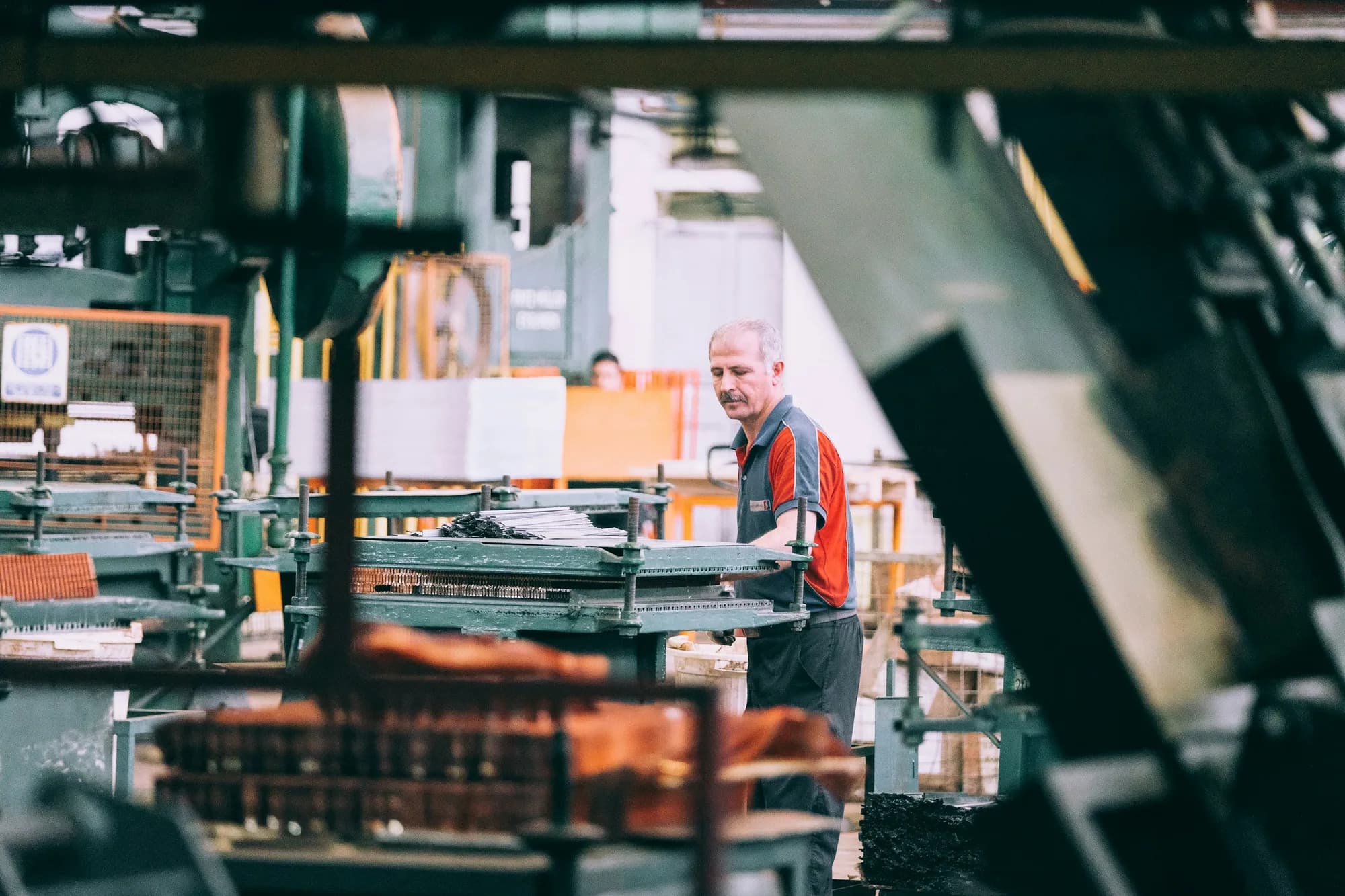An experienced operator working on a manufacturing floor.